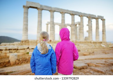 Two Young Sisters Exploring The Ancient Greek Temple Of Poseidon At Cape Sounion, One Of The Major Monuments Of The Golden Age Of Athens.