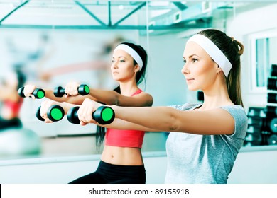 Two young sporty woman in the gym centre. - Powered by Shutterstock