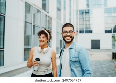 Two young students man and woman going to university together - Powered by Shutterstock