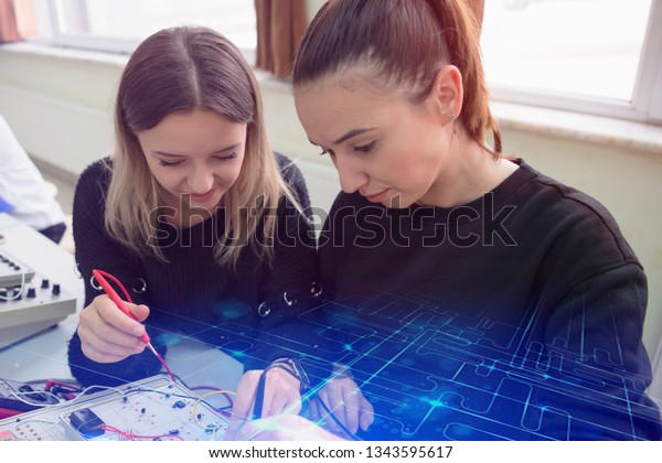 Two\
young students in technical vocational training, the lesson in\
technical college. Education and technology\
concept.