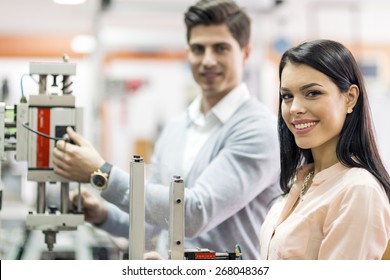 Two Young Students Working On A Science Project Together In Lab