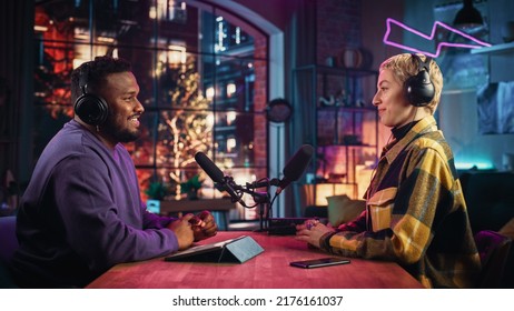 Two Young Stylish Radio Show Hosts Record Fresh Podcast Episode in Home Loft Studio Apartment. Attractive Energetic Co-hosts Discuss Important Topics Live on Air in an Evening Show. - Powered by Shutterstock