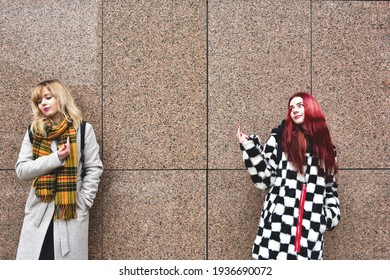 Two Young Teenage Girls Got Into A Conflict. Quarrel, Aggression, Stress. Two Girlfriends Tell Each Other To Fuck Off By Showing The Middle FingerTwo Young Women Are Cursing. Quarrel, Aggression, Stre