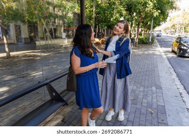 Two young tourists using a map to navigate the city and plan visits to famous monuments and museums.