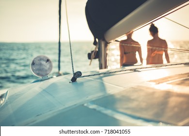 Two Young Woman Watching The Sea Horizon From A Luxury Yacht While Sailing. Abstract Sunset Outdoors Activity Background