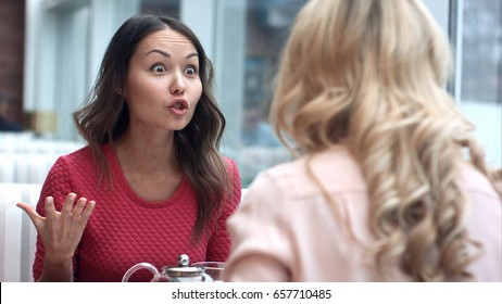 Two Young Women Argue In Cafe