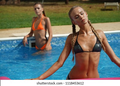 Two young women bathing in swimming pool