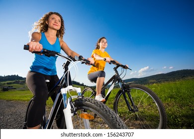 Two Young Women Biking