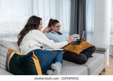 Two Young Women Couple Making Their Online Business For Shopping Booking And Restaurant Reservation As Internet App Service. Lesbian Girls Working On Plans And Ideas For Their New Small Company.