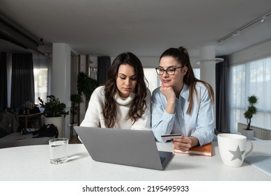 Two Young Women Couple Making Their Online Business For Shopping Booking And Restaurant Reservation As Internet App Service. Lesbian Girls Working On Plans And Ideas For Their New Small Company.