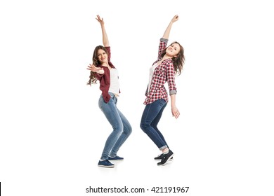 Two Young Women Dancing Over White Background 