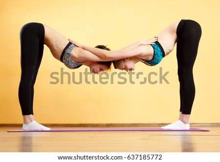 Two young women doing yoga