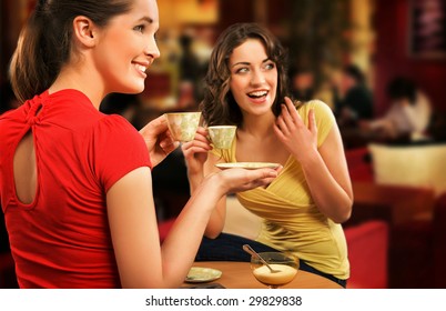 Two Young Women Having Coffee Break Together