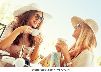 Two Young Women Having Coffee Break After Good Shopping.