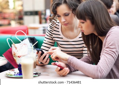 Two Young Women Having Coffee Break Together