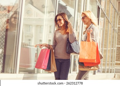 Two young women looking in showcase