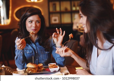 Two young women at a lunch in a restaurant