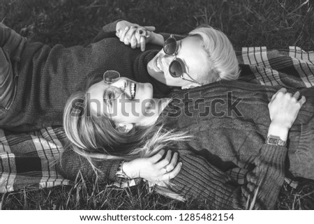 Similar – Two women with sunglasses smiling lying in blanket