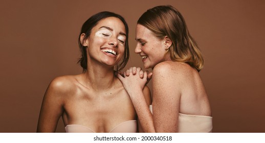 Two Young Women With Skin Condition Standing Together On Brown Background. Woman With Diverse Skin Accepting Their Natural Beauty.