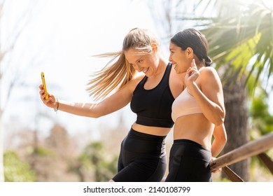 Two Young Women Take A Selfie In The Park While Playing Sports