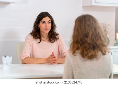 Two Young Women Talking In A Consultation