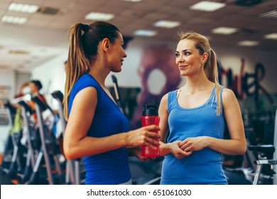 Two Young Women Talking In A Gym During A Break