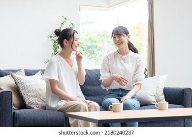 Two Young Women Talking At Home