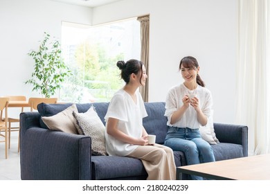 Two young women talking at home - Powered by Shutterstock