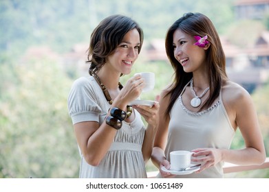 Two Young Women Together Outside Having Coffee