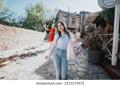 Two young women walking in an alley with cobblestone pavement, one holding a coffee cup, exuding casual relaxation and friendship. - Powered by Shutterstock