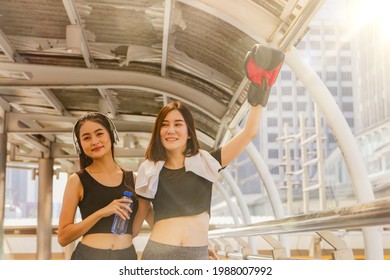 Two Young Women Walking Warmed Up, Drank Water And Talked About Simple Things On The City Corridor : Young Woman With A Fresh Mind Comes To Exercise In The Morning.