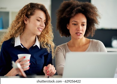Two young women working on the laptop - Shutterstock ID 629256422