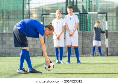 Two Youth Teams Play Football. Free Kick On Goal