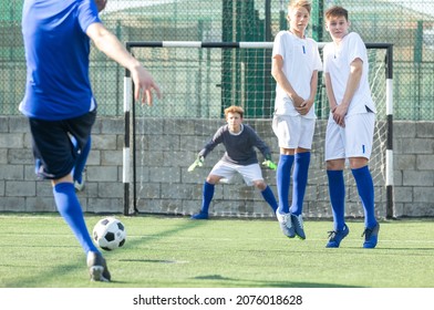 Two Youth Teams Play Football. Free Kick On Goal