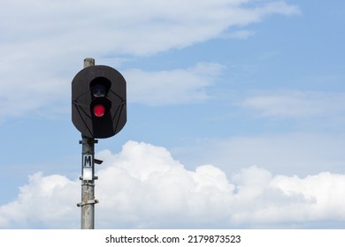 Two-aspect Colour Light Railway Signal With Displayed Red Light Set At Danger And To Stop Over Blue Sky