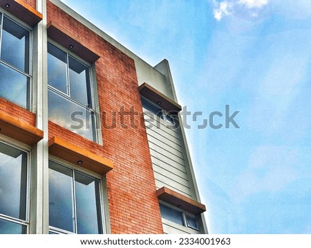 A two-storey building with a minimalist model with red brick accents. Minimalist and elegant.