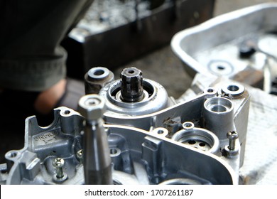 The two-stroke motorcycle engine is repaired by a mechanic. - Shutterstock ID 1707261187