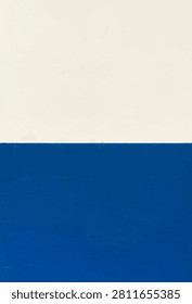 Two-tone painted concrete wall with a sharp horizontal split between off-white and vibrant blue.