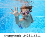 two-year-old boy himself swims in the pool underwater