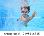 two-year-old boy himself swims in the pool underwater