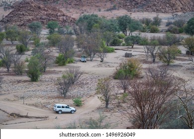 Twyfelfontein, Namibia, November 2012: Nearly Empty Camp Site, With Two Trucks, In The African Bush