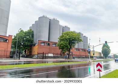 Tychy, Poland - June 5, 2021: Street view on storage and fermentation tanks of Tyskie brewery belong to Kompania Piwowarska at rainy day.