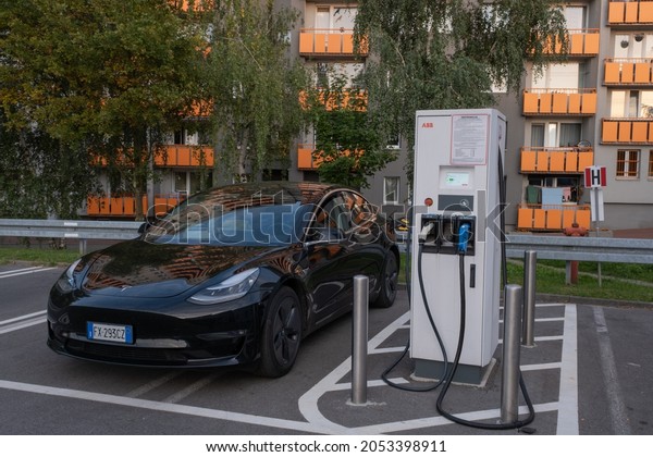 Tychy,
Poland - September 26, 2021. A static shot of a solid black Tesla
Model 3 dual motor charging at the Kaufland supermarket DC charging
station in a sunny autumn day. Selective
focus.