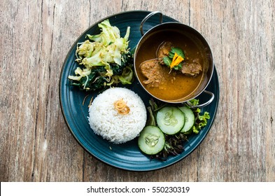 Tyical Indonesian dish: Rendang beef served with vegetables and rice