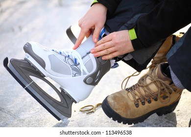 Tying Laces Of Ice Hockey Skates At Skating Rink