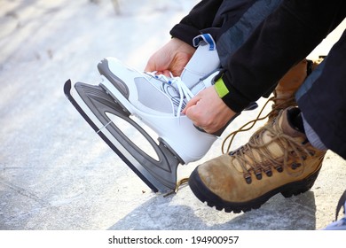 Tying Laces Of Ice Hockey Skates At Skating Rink