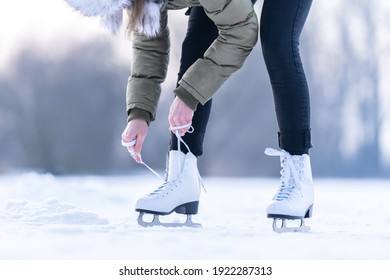 Tying The Laces Of Winter Skates On A Frozen Lake, Ice Skating