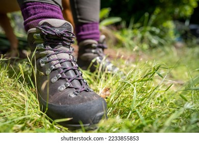 Tying shoelaces on hiking boots by a girl on a hike in spring - Shutterstock ID 2233855853