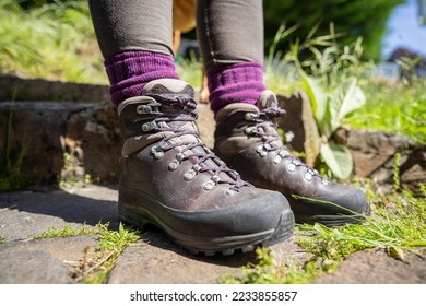 Tying shoelaces on hiking boots by a girl on a hike in spring - Shutterstock ID 2233855857