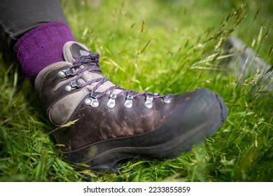 Tying shoelaces on hiking boots by a girl on a hike in spring - Shutterstock ID 2233855859